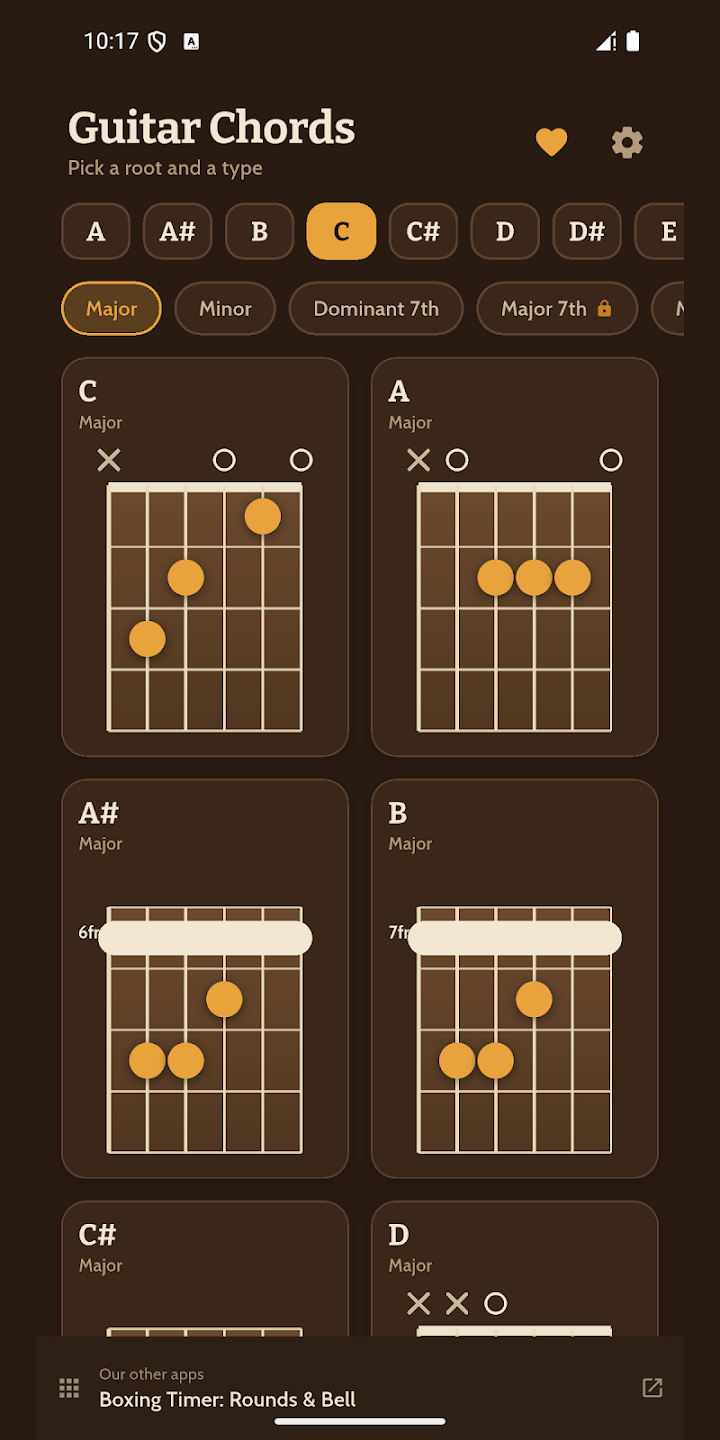 Ecran d'accords de guitare sur fond brun sombre, avec une rangee de notes de A a G, et une grille de diagrammes de manche ou les positions de doigts sont marquees par des pastilles orange